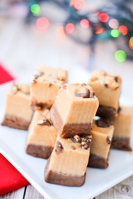 AMAZING Easy Chocolate Peanut Butter Fudge Recipe-A layer of chocolate fudge topped with a layer of peanut butter fudge and sprinkled with Reese's. It's perfection! The best Christmas treat. #christmastreats #Christmasdessert