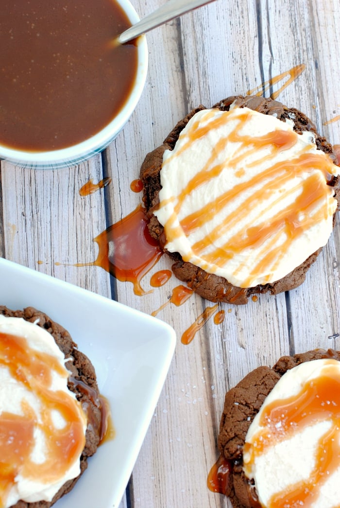 Chocolate Salted Caramel Cookies Recipe-These chocolate cookies are soft and chewy and thick, topped with caramel buttercream frosting, drizzled in caramel sauce and sprinkled with salt. They are so good they will probably be your new favorite dessert. #cookies #chocolate #caramel