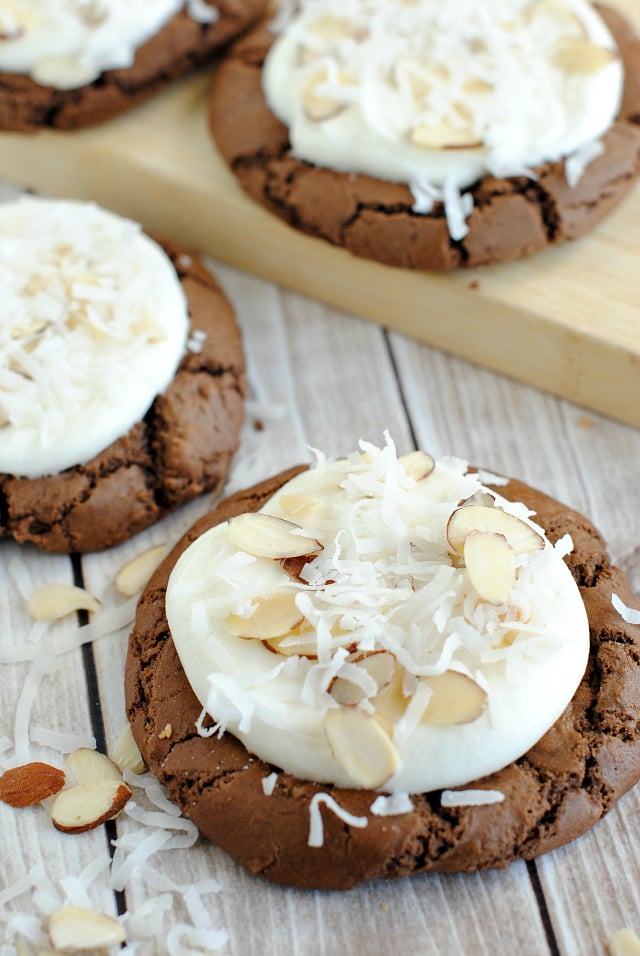 Almond Joy Cookies-These soft and chewy chocolate cookies are topped with coconut frosting and sprinkled with coconut and almonds to make a wonderful cookie recipe. #cookies #dessert #dessertrecipe #coconut